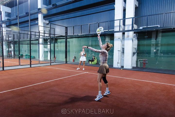 A serve on the red indoor court